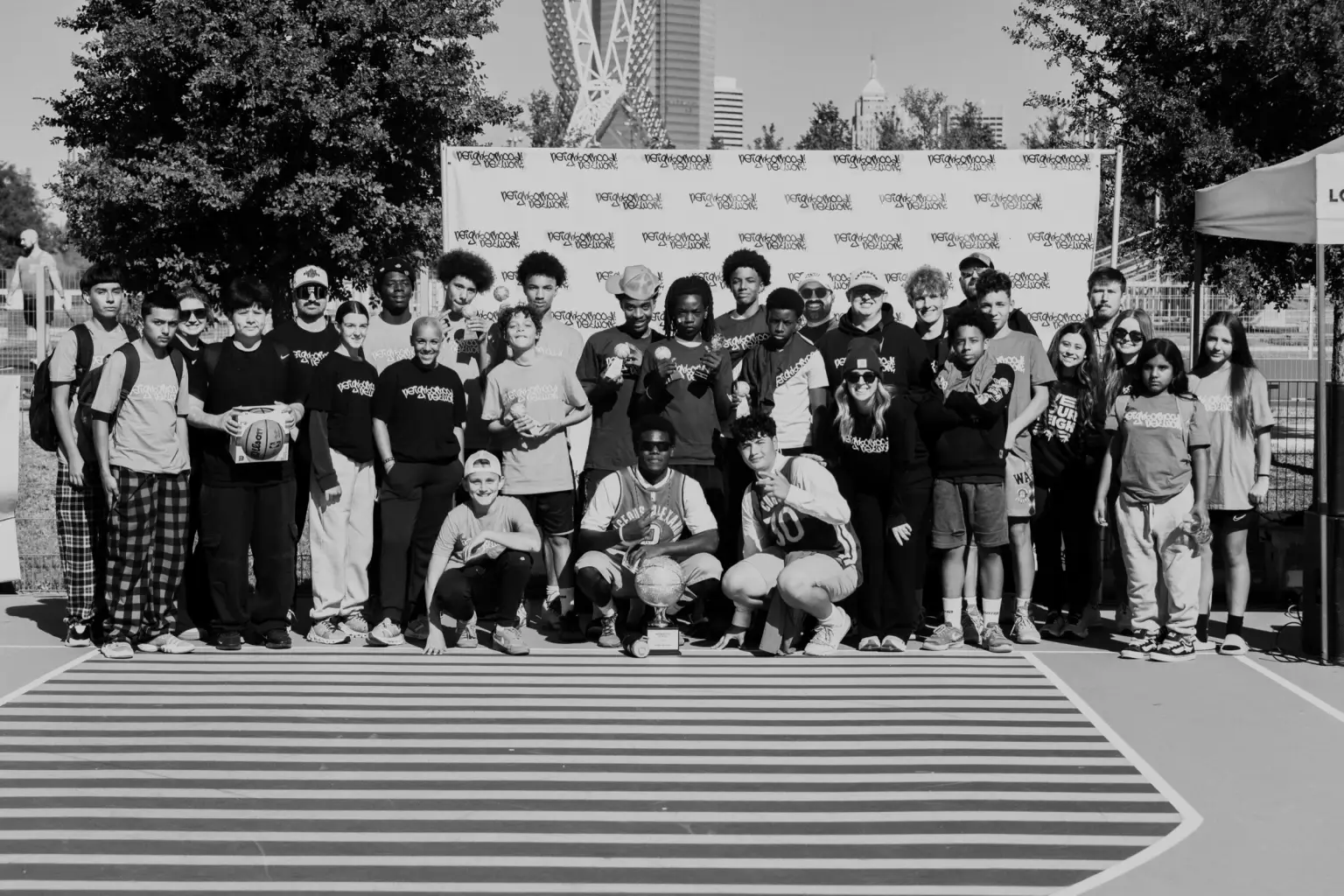 Students and leaders gathered at center court on tournament day, with the Oklahoma City skyline behind them